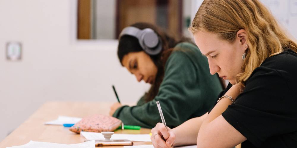 improve sitting tolerance with activities - two teens doing homework